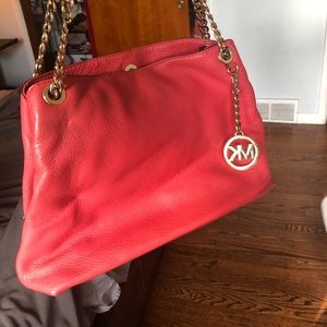 Coral pink Michael Kors purse. Great summer bag. Has a small pen mark.
